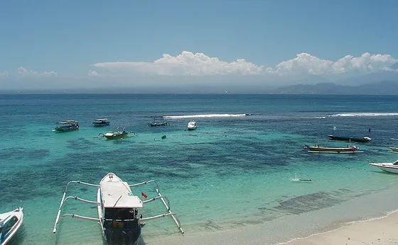 Boats moored in the turquoise water of Mushroom Bay